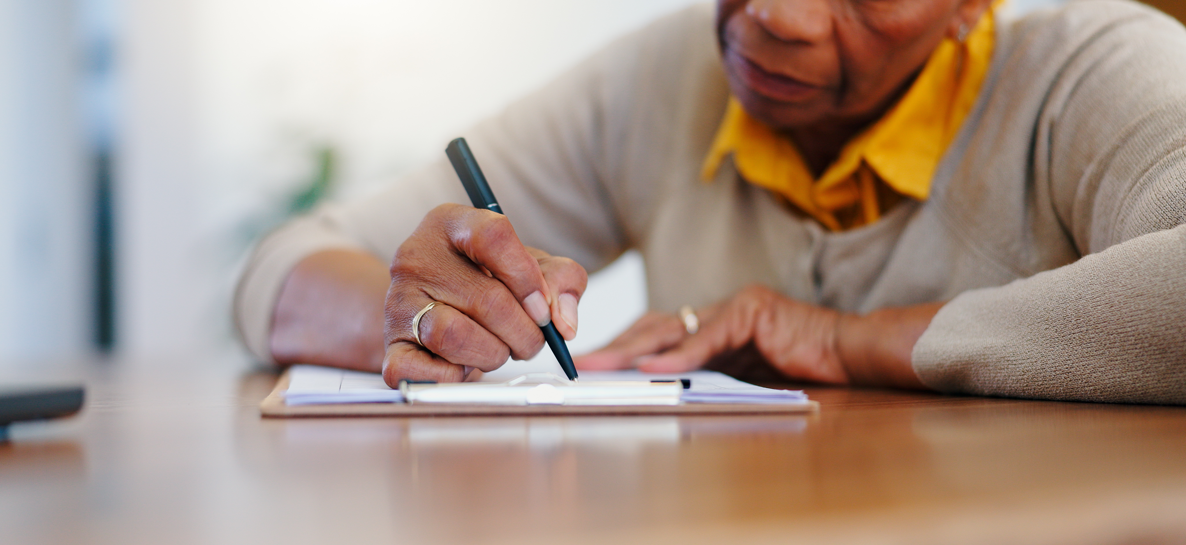 Senior woman signing document