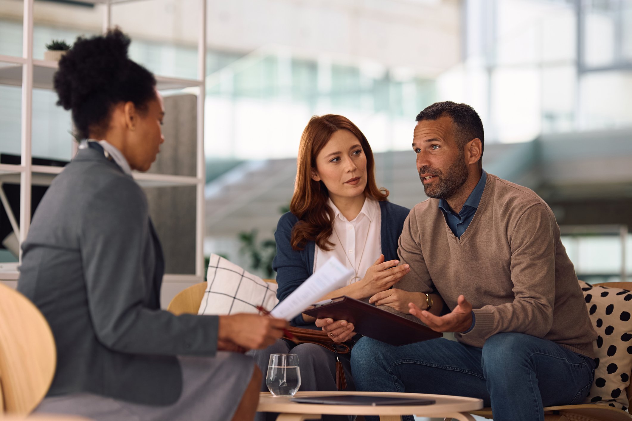 Couple reviewing documents with lawyer